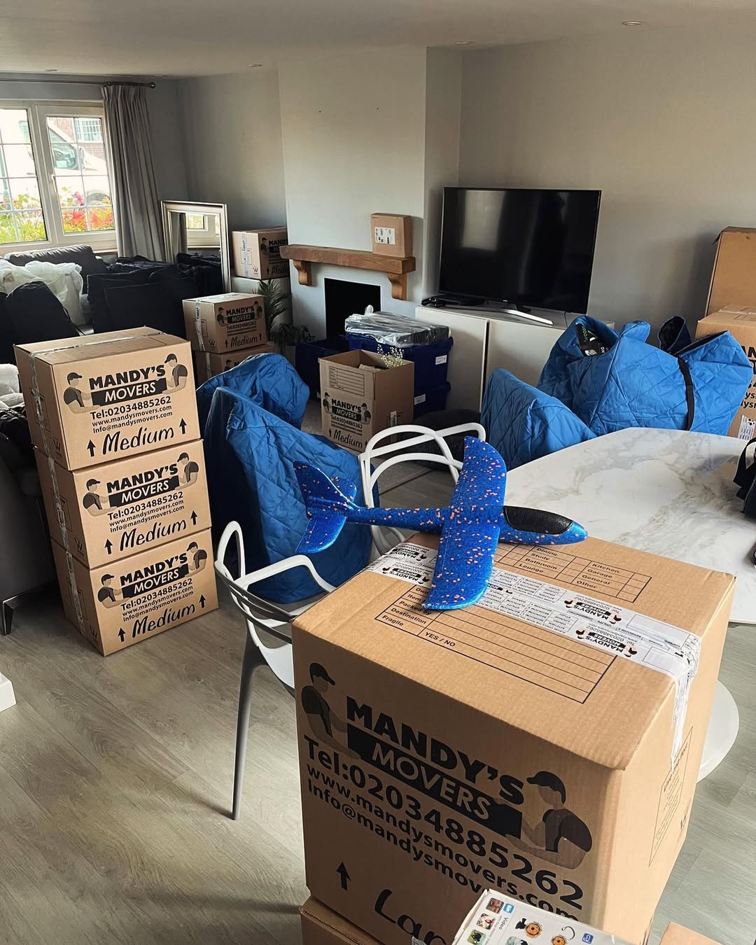 2 mandys movers vans outside house for house move